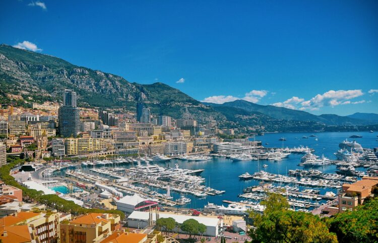 Luxury yachts docked in Monte Carlo, Monaco, with stunning Mediterranean views and elegant architecture—one of the best luxury destinations to visit in June.